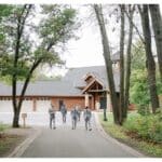 Groomsmen walking towards event venue.