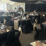 Elegant banquet hall with decorated tables.