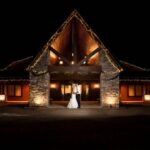 Couple embracing outside illuminated venue