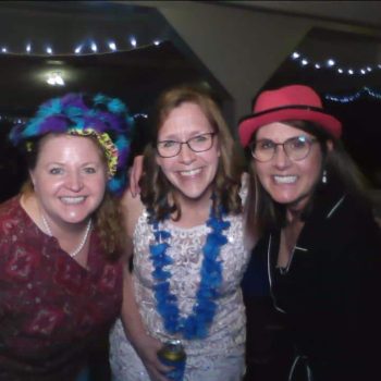 Three women at a festive gathering.
