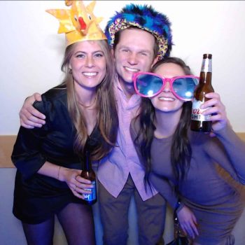Three people celebrating with drinks