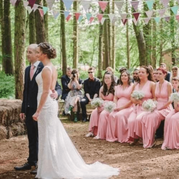 Outdoor wedding with pink bridesmaids.